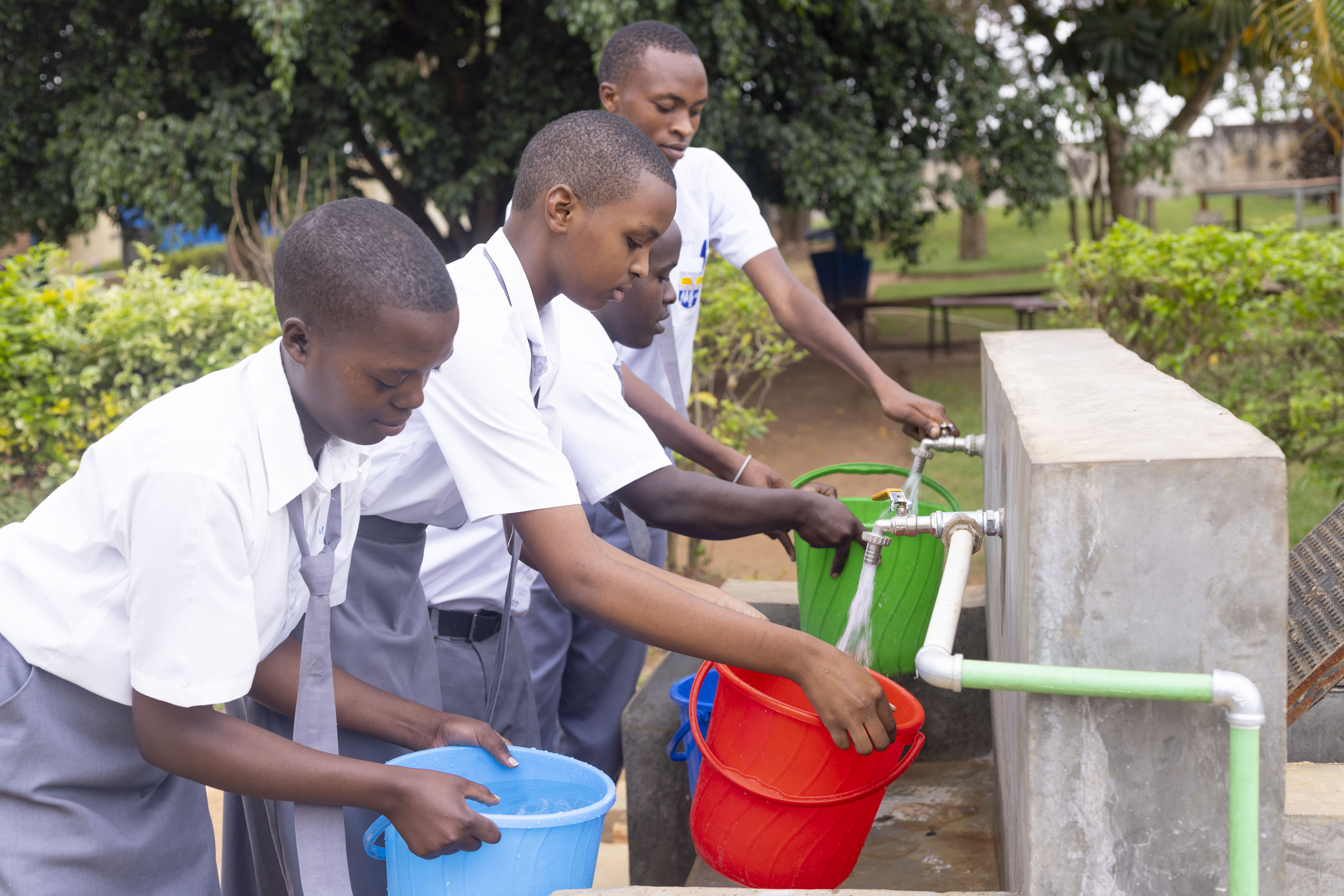 Students fetching water at one of the schools